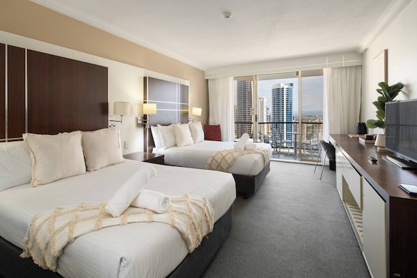 Rest well on two comfortable queen beds, enhanced by soft ambient lighting and blackout blinds that ensure an undisturbed night’s sleep.