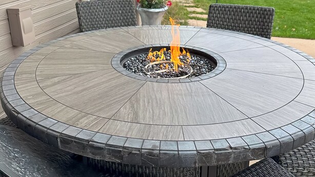 A circular outdoor table with a built-in fire pit, surrounded by wicker chairs. - 4 Mi to Broadmoor! Apt w/ Movie Theater & Mtn View (Colorado Springs)