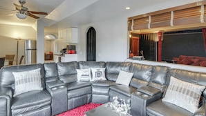 A modern living room with a sectional sofa, a coffee table, and a red rug. - 4 Mi to Broadmoor! Apt w/ Movie Theater & Mtn View (Colorado Springs)