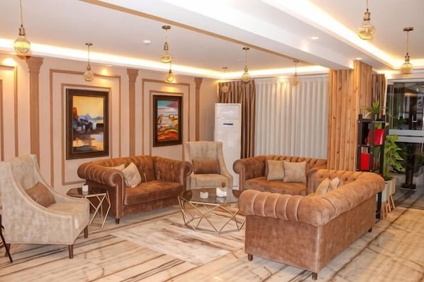 A modern living room with sofas, armchairs, and a coffee table.