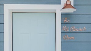 A light blue door with a keyhole and a small electronic lock.