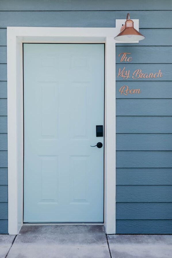 A light blue door with a keyhole and a small electronic lock.