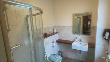 Shower, hair dryer, towels, toilet paper