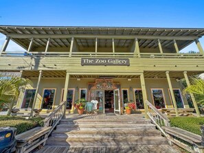 A building with a sign reading 'The Zoo Gallery' and a wooden deck leading to the entrance.