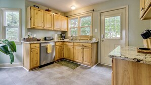 A kitchen with wooden cabinets, a dishwasher, a sink, and a countertop with a knife block. - Home 2 Mi to Shenandoah Nat'l Park & Skyline Drive (Front Royal)