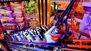 A multi-level indoor amusement park with various rides and attractions.