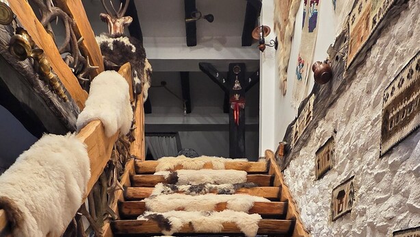 A staircase with wooden steps and fur rugs. - Agi Traditional  (Bran)