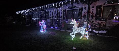 A building with string lights and a reindeer decoration.