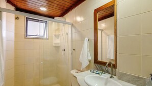 A bathroom with a shower, toilet, sink, and a mirror. - Fully Equipped Apartments Just Steps From Barra Beach and Barra Lighthouse - Csfs (Salvador)