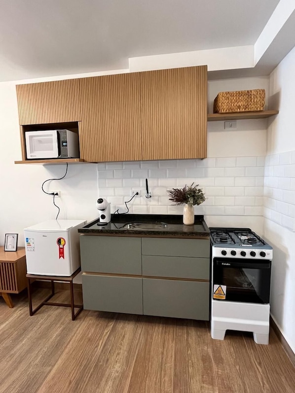 Mini-fridge, microwave, oven, cookware/dishes/utensils