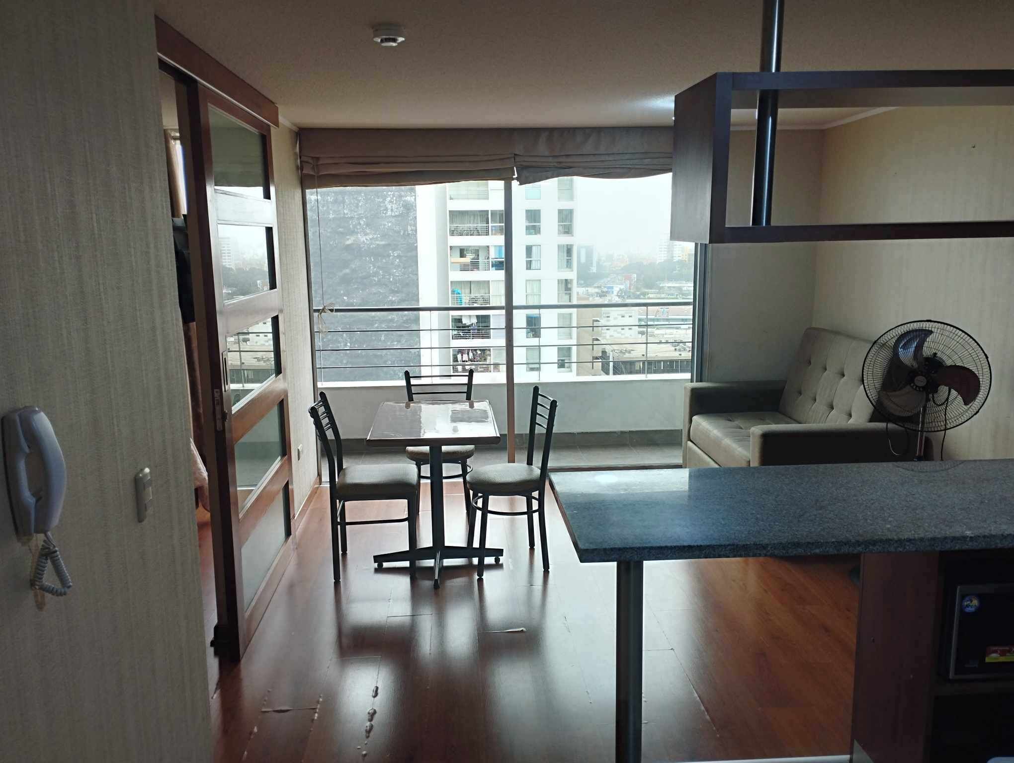 A modern apartment with a balcony, a dining area, and a living space.