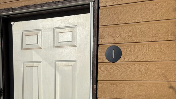 A white door with a brass doorknob and a black frame. - Charming 2-bedroom Getaway in Broadus (Broadus)