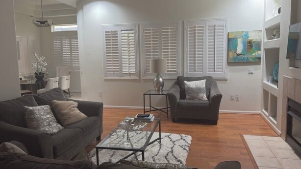 A modern living room with a sofa, armchair, coffee table, and a fireplace. - TPC golf course North Scottsdale. (Scottsdale)