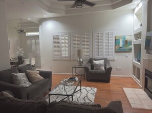 A modern living room with a sofa, armchair, coffee table, and a fireplace. - TPC golf course North Scottsdale. (Scottsdale)