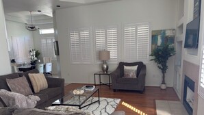 A modern living room with a grey sofa, a coffee table, and a fireplace. - TPC golf course North Scottsdale. (Scottsdale)
