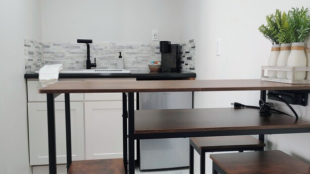 A compact kitchen with a countertop, a coffee maker, and a potted plant. - Welcoming studio in Roseville perfect for a cozy getaway (Roseville)