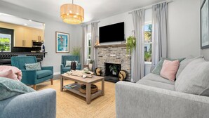 Una sala de estar moderna con chimenea, televisor y asientos cómodos.