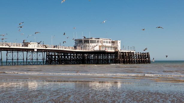 A pier extending into the water with a building at the end. - Seasalt Retreat By My Getaways (Worthing)