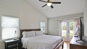A bedroom with a bed, a ceiling fan, a nightstand, a dresser, and a window with blinds. - Charming Bradenton getaway on the Gulf Coast - Flip Flop Retreat (Bradenton)