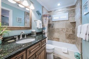 A bathroom with a marble sink, a toilet, and a bathtub. - Palm Gables 112 :NO ELEVATOR Jul 25 - Nov 15, 2026 - Gulf Front Condo, Pool, Beach Access (Holmes Beach)