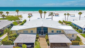 A beachfront hotel with a central building, multiple parking spaces, and a beach view. - Combined Beachfront Bliss - Aloha Kai #24 & #24N - Roelens (Siesta Key)
