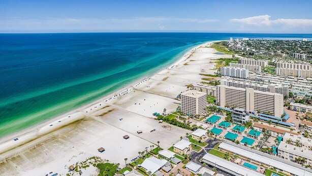 An aerial view of a coastal resort area with beachfront properties, a marina, and a golf course. - Combined Beachfront Bliss - Aloha Kai #24 & #24N - Roelens (Siesta Key)