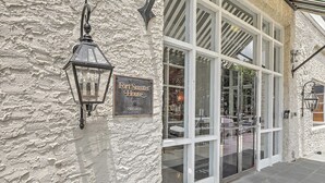 A building with a textured exterior wall, a sign reading 'Fort Summer House Private Residence,' and a large glass entrance.