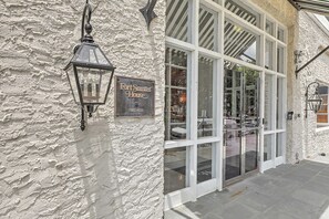 A building with a textured exterior wall, a sign reading 'Fort Summer House Private Residence,' and a large glass entrance.