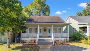 A two-story house with a front porch, a mailbox, and a small front yard. - Charming 3BR Downtown Natchitoches Home, 1.5 Bath, Walking Distance to Front St (Natchitoches)