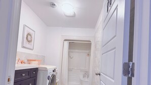 A modern bathroom with a shower, toilet, and washing machine. - Private Basement + Self Check-in + Kids/Family + Parking (Bedford)
