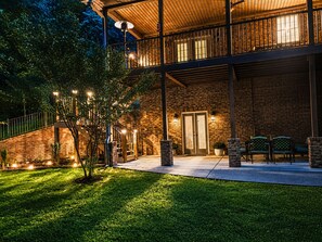 A building with a brick exterior, a balcony with railings, and outdoor seating. - Cozy Ellijay Retreat Near Downtown, Wineries & Apple Orchards (Ellijay)