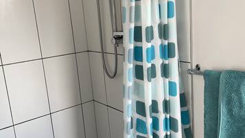 Shower, hair dryer, towels, toilet paper