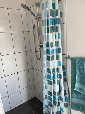 Shower, hair dryer, towels, toilet paper