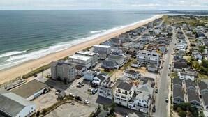 A coastal residential area with a beachfront, houses, and a road. - Rooftop Tide | Ocean Views | Gas Fireplace (Salisbury)