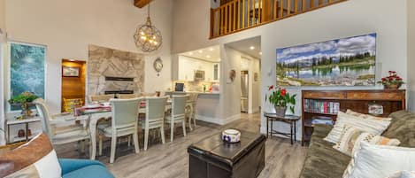 A spacious living area with a dining set, a coffee table, and a sofa.