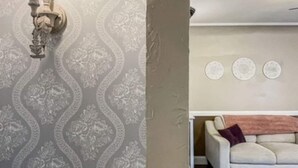 A room with a patterned wallpaper, a candelabra, a white sofa, and a patterned rug. - Sweet & Petite Midtown Cottage for 5-Long Stays Welcome (Billings)