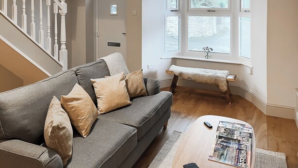 A living room with a grey sofa, a wooden coffee table, and a bench by the window. - 2 bedroom accommodation in Crook, near Bishop Auckland (Crook, near Bishop Auckland)