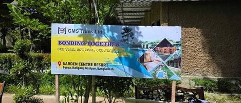 A signboard for Garden Centre Resort in Berua, Kaliganj, Gazipur, Bangladesh, with a logo and a map.