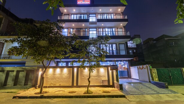 A multi-story hotel with a prominent sign reading "Hotel Aura Grand." - Hotel Aura Grand SECTOR - 63A Noida (Noida)