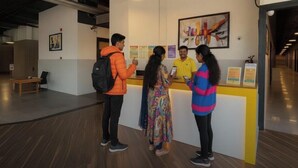 A reception area with a counter, a bench, and a wall with framed artwork. - The Metrostay Delhi (New Delhi)