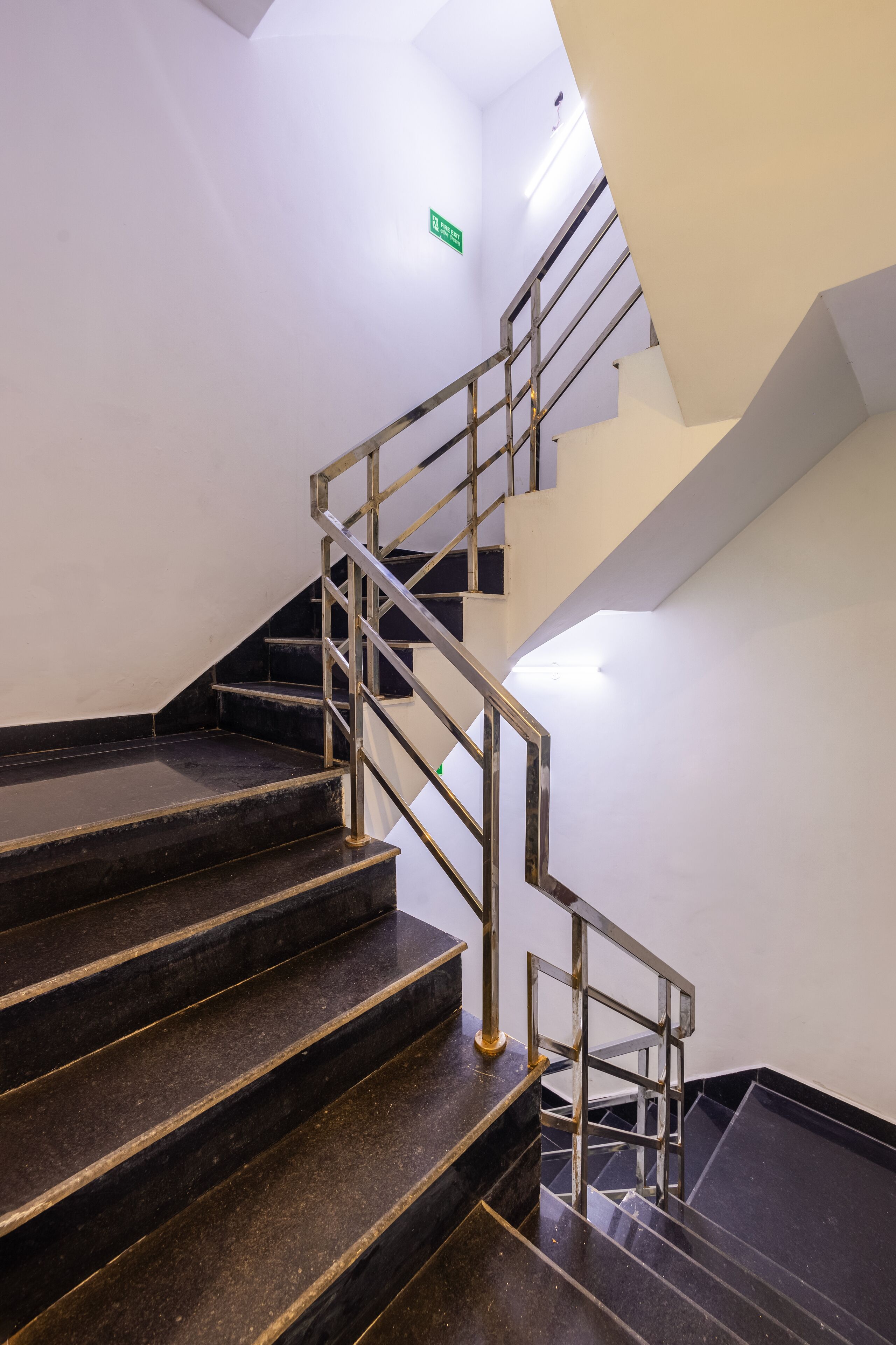 A staircase with metal railings and dark marble steps.