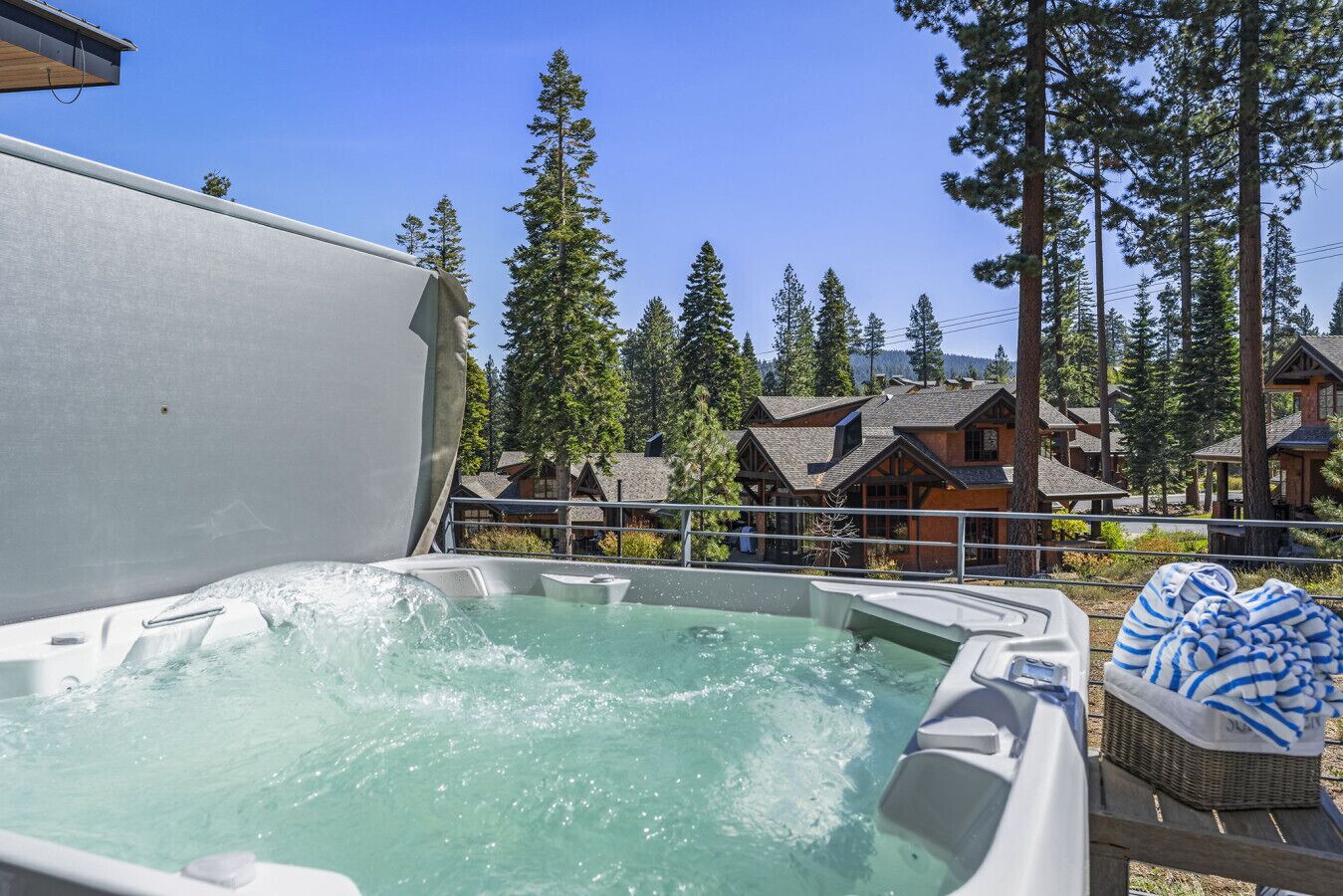 A hot tub with a clear view of surrounding buildings and trees.
