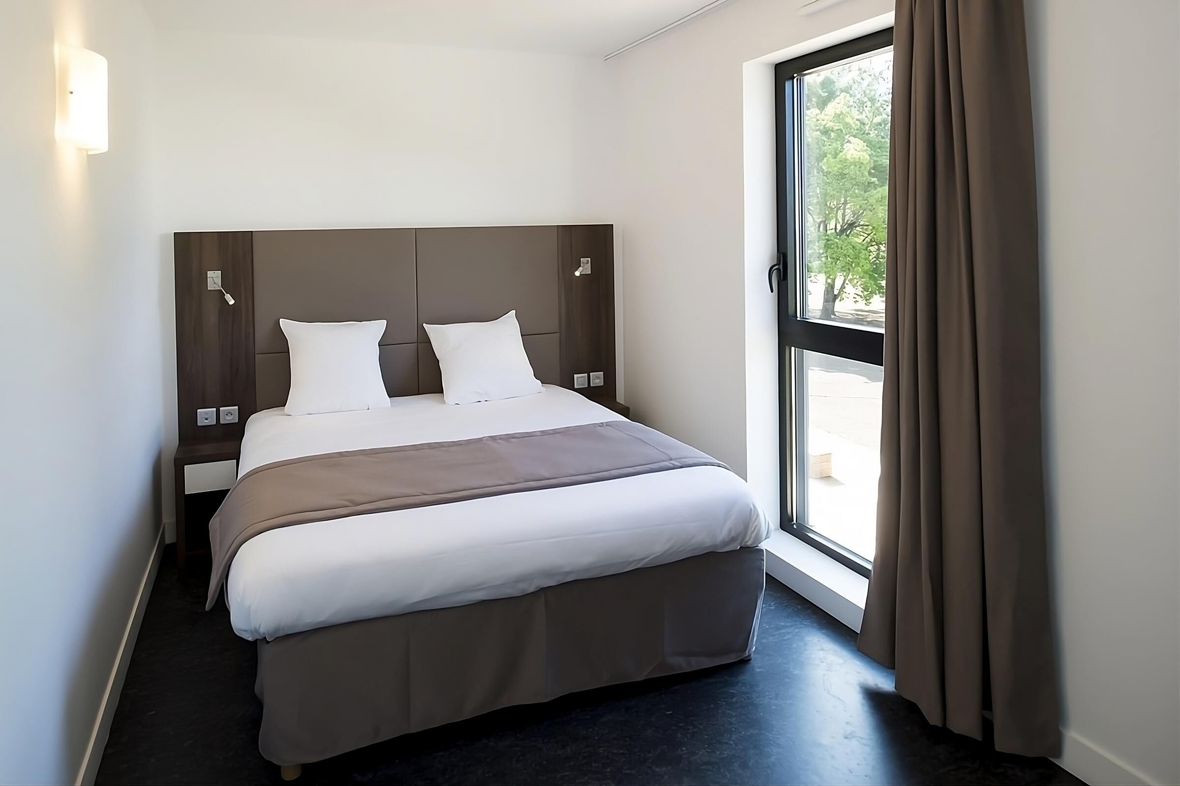 Wake up refreshed beside tall windows and calming neutral tones.