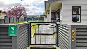A gated entrance to a South Stays property with a clear pathway leading to the building. - Luxmore Lookout Te Anau (Te Anau)
