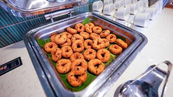 A buffet with a variety of fried snacks arranged on a tray.