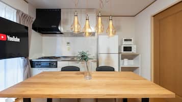 Apartment, Balcony | Living area | 65-inch flat-screen TV with digital channels