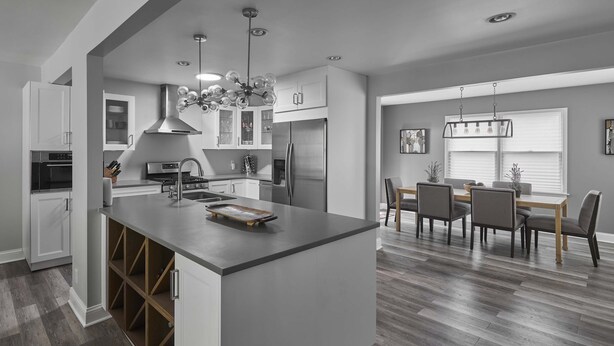 A modern kitchen with white cabinetry, stainless steel appliances, and a central island. - Funtana Home for 8 (Fontana)