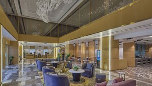 A spacious lobby with a high ceiling, modern seating arrangements, and a reception area. - Grand Continent- A Luxury Collection Udaipur (Udaipur)