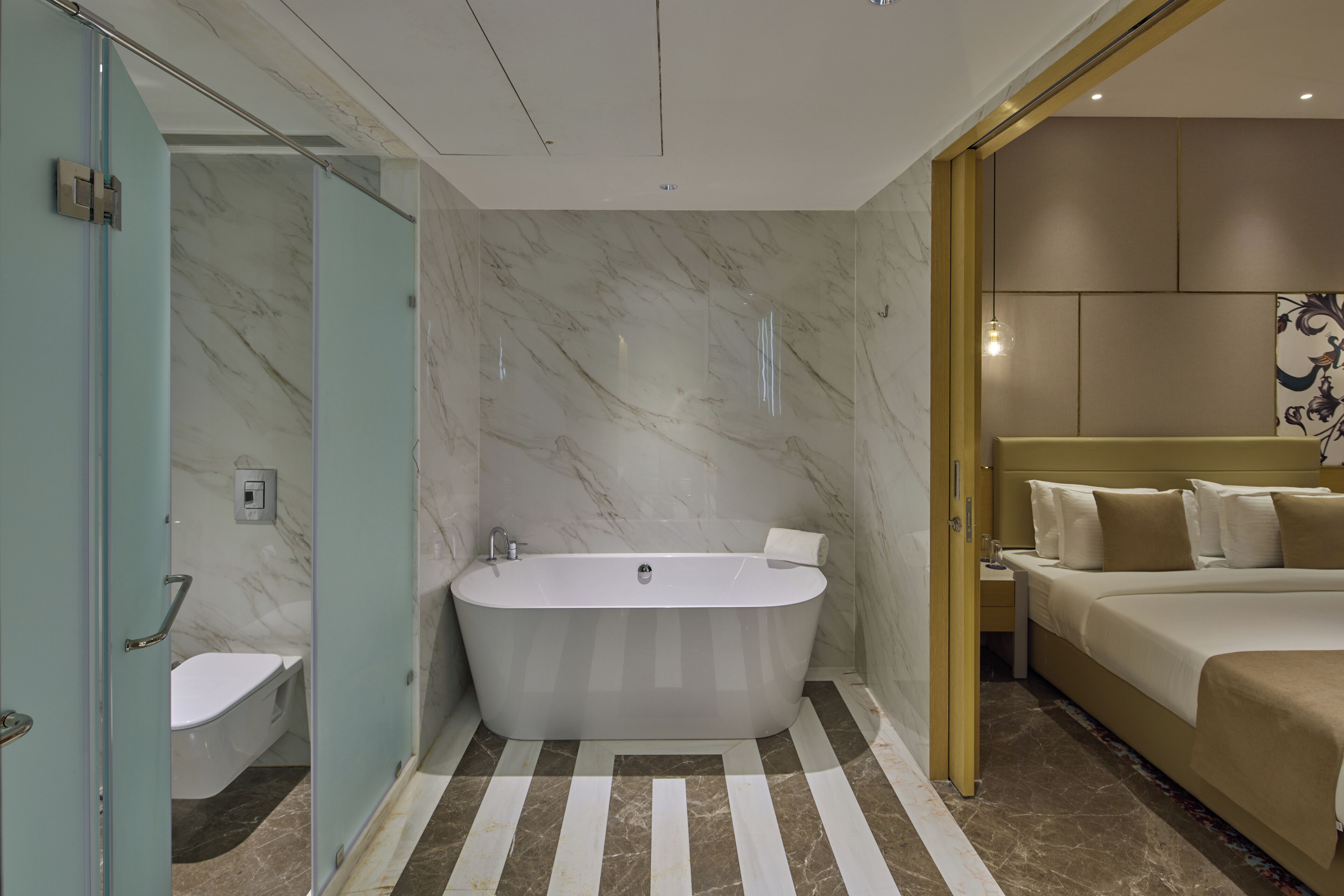 A modern bathroom with a freestanding bathtub, a toilet, and a shower area.