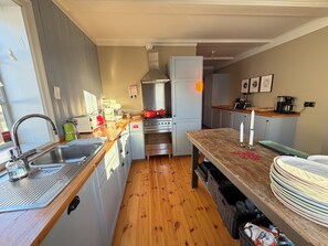 A compact kitchen with a sink, stove, and refrigerator.